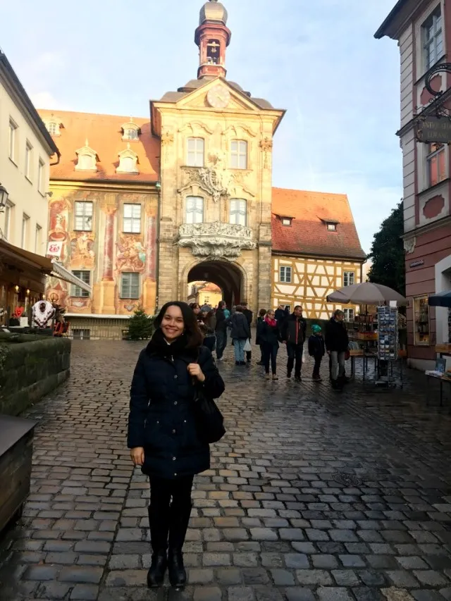 Woman standing near the famous bridge in Bamberg, Germany.