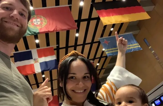 Multicultural family holding flags representing their diverse heritage and backgrounds