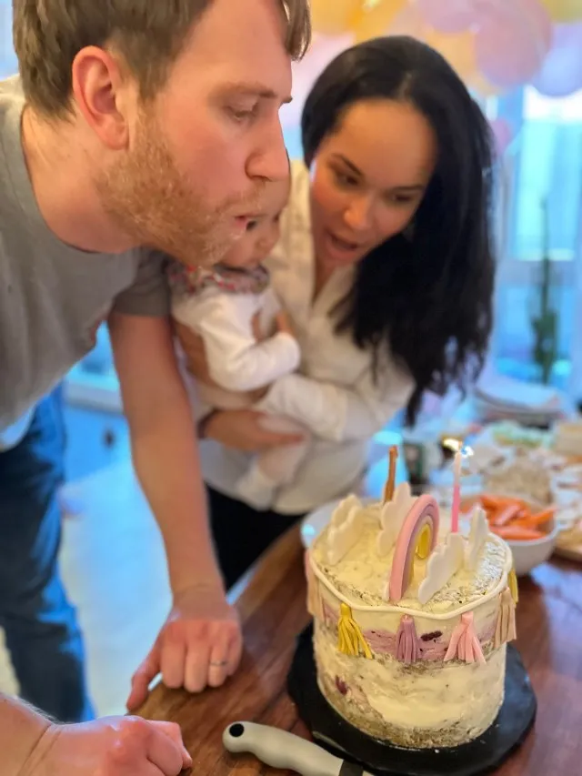 Mother and father celebrating child's first birthday party.